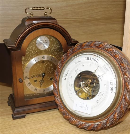 An oak-cased aneroid barometer and a later mantel clock